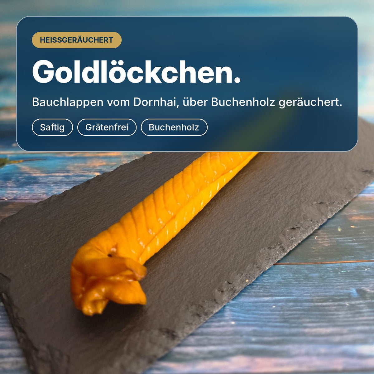 Goldlöckchen: heißgeräucherte Schillerlocke vom Dornhai auf Schiefer, über Buchenholz geräuchert, goldgelb, saftig und grätenfrei.